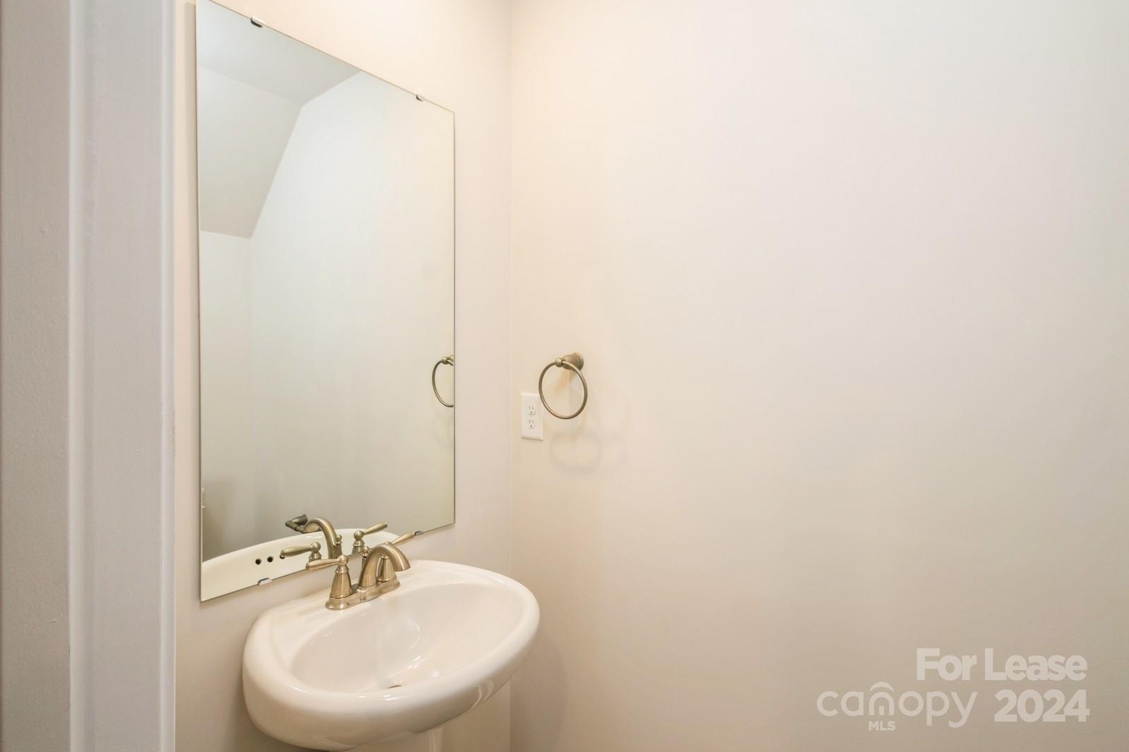 131 Brixham Loop Troutman, NC 28166 - Photo 23 of 26 a bathroom with a sink and mirror