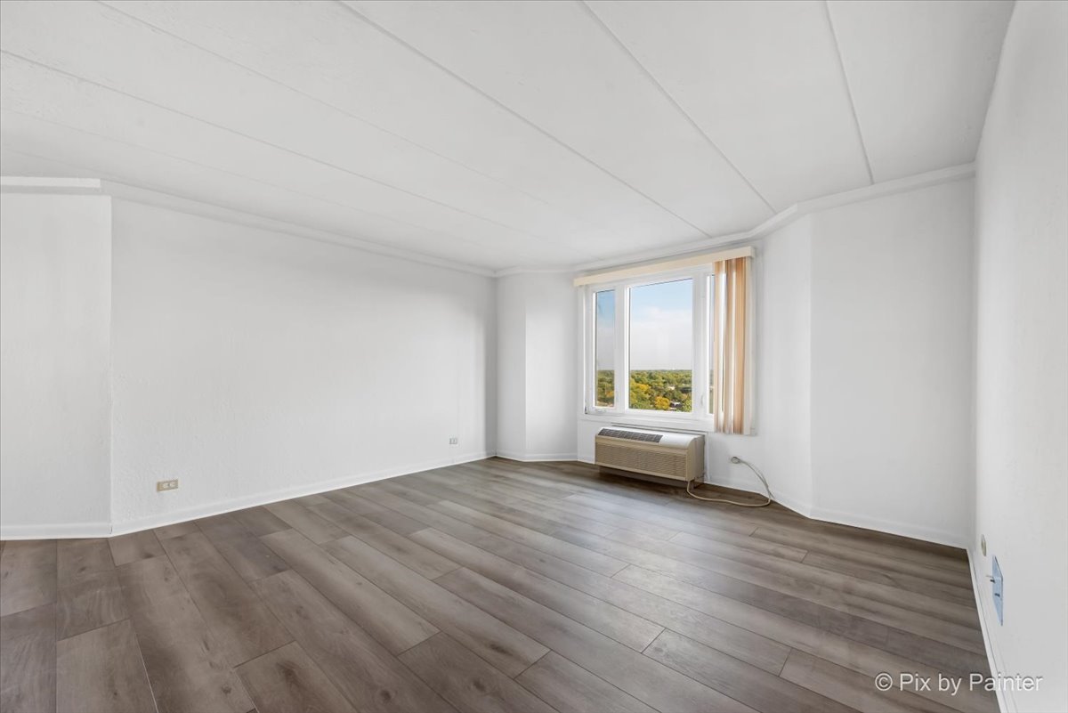 1 Renaissance Place, Unit 1017 Palatine, IL 60067 - Photo 13 of 30 a view of an empty room with wooden floor and a window