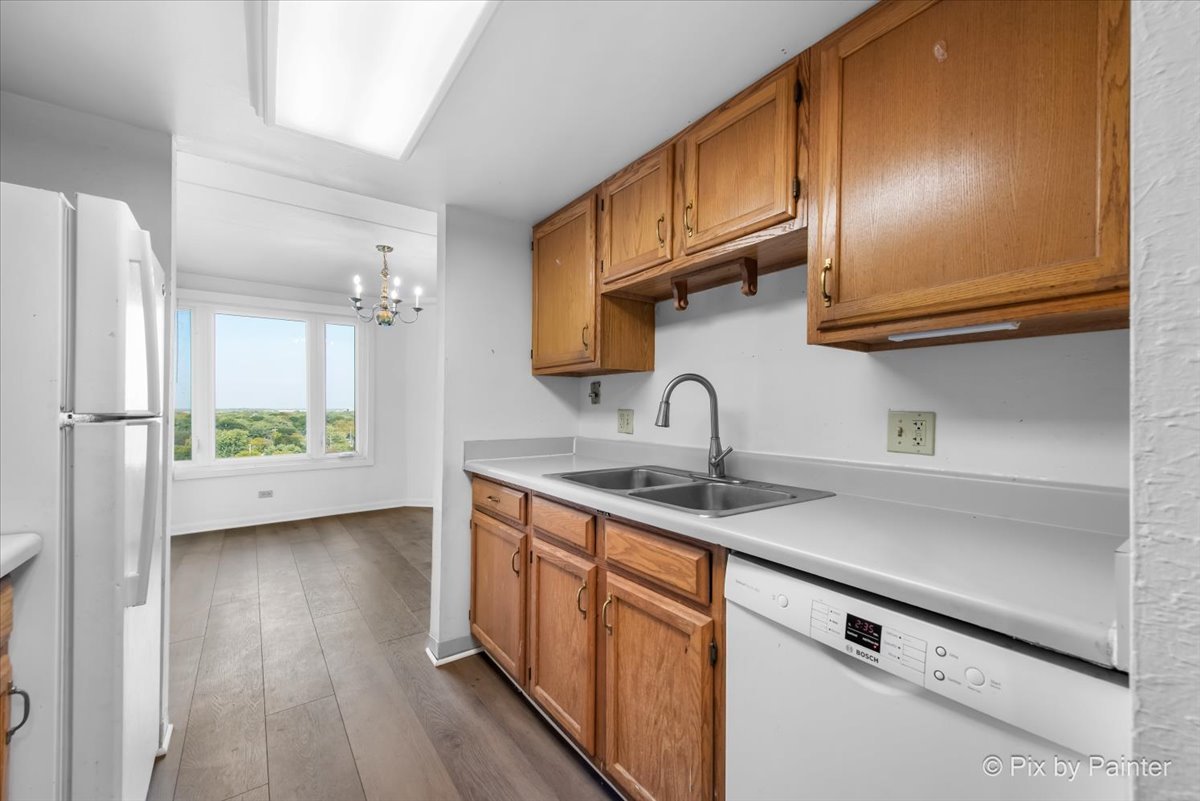 1 Renaissance Place, Unit 1017 Palatine, IL 60067 - Photo 7 of 30 a kitchen with stainless steel appliances granite countertop a sink a stove and a wooden floors