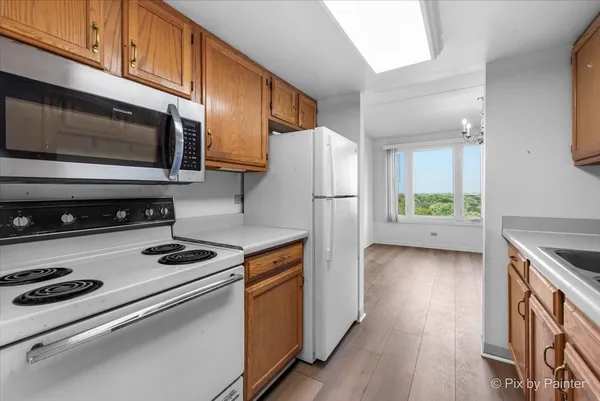 a kitchen with stainless steel appliances a stove a microwave and a refrigerator