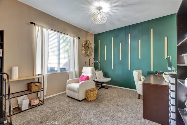 a bedroom with furniture and a large window