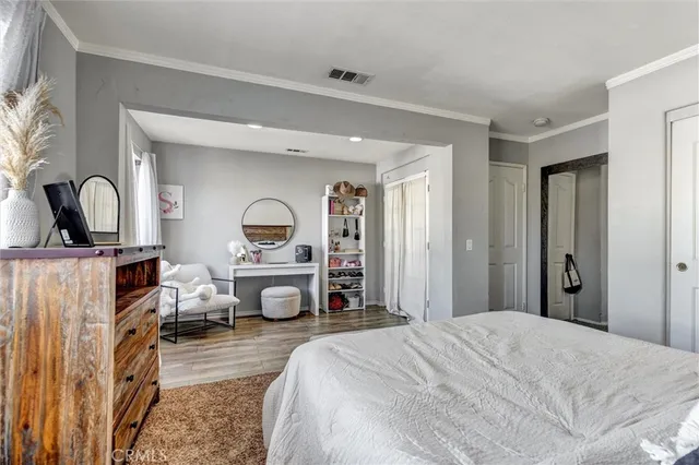 a bedroom with a bed next to a window and a dresser