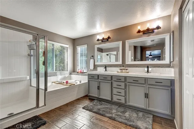 a spacious bathroom with a double vanity sink mirror and bathtub