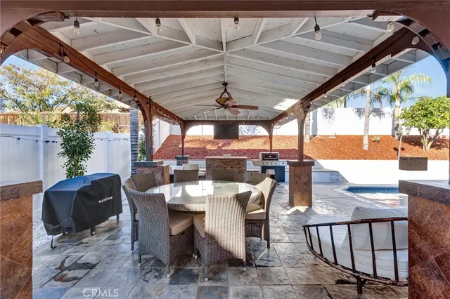 a view of a patio with a table and chairs