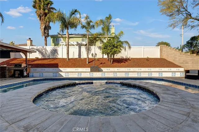 a living room with furniture a fireplace and a potted plant