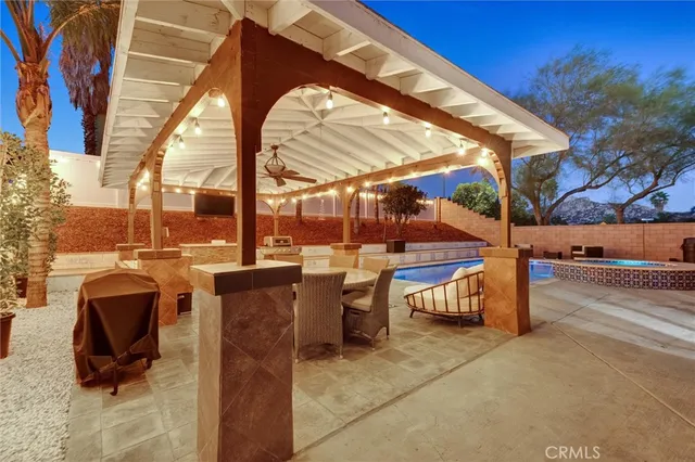 a dining room with furniture and a chandelier