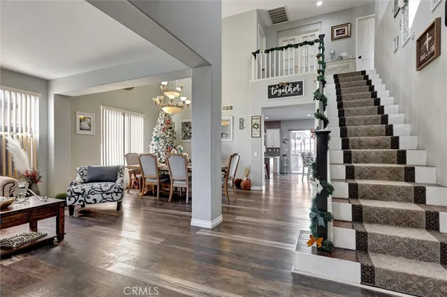 a view of entryway and hall with wooden floor