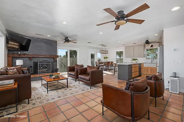 a kitchen with granite countertop a refrigerator and a stove top oven