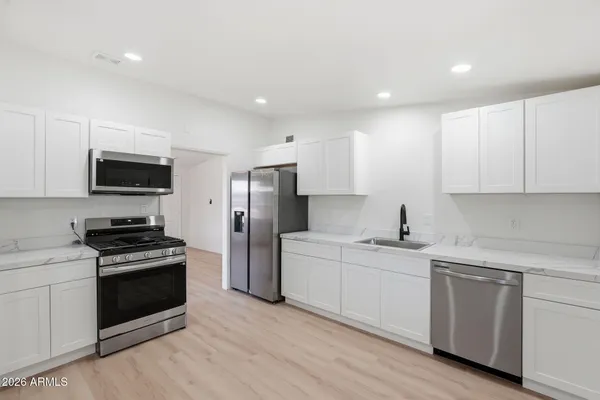 a kitchen with a sink a stove and refrigerator