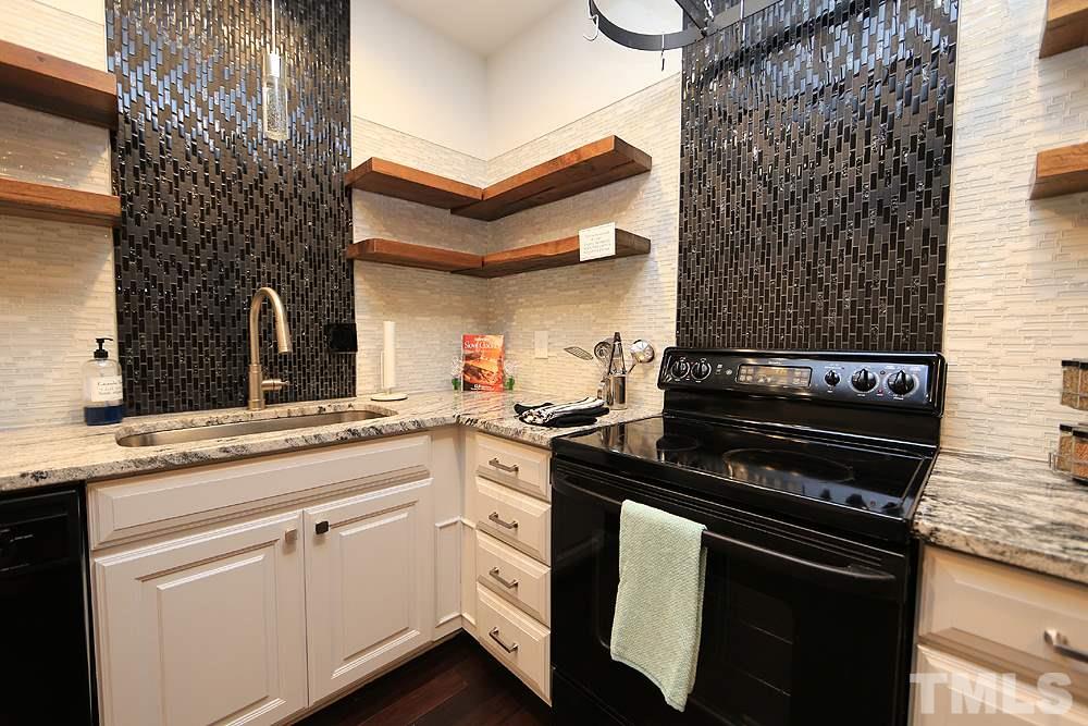 6579 New Market Way, Unit 6579 Raleigh, NC 27615 - Photo 1 of 22 a kitchen with cabinets and appliances