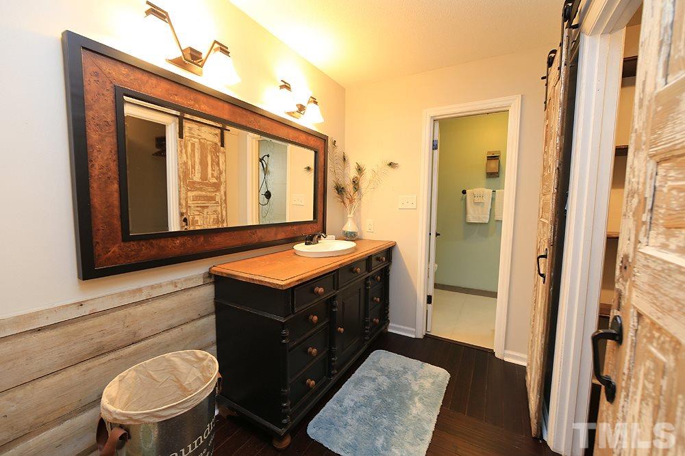 6579 New Market Way, Unit 6579 Raleigh, NC 27615 - Photo 22 of 22 a bathroom with a sink a toilet and shower