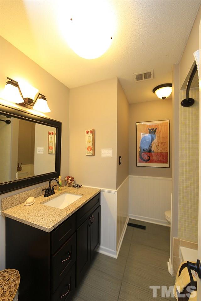 6579 New Market Way, Unit 6579 Raleigh, NC 27615 - Photo 15 of 22 a bathroom with a sink and a mirror