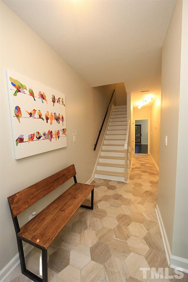 6579 New Market Way, Unit 6579 Raleigh, NC 27615 - Photo 19 of 22 a view of a hallway with stairs