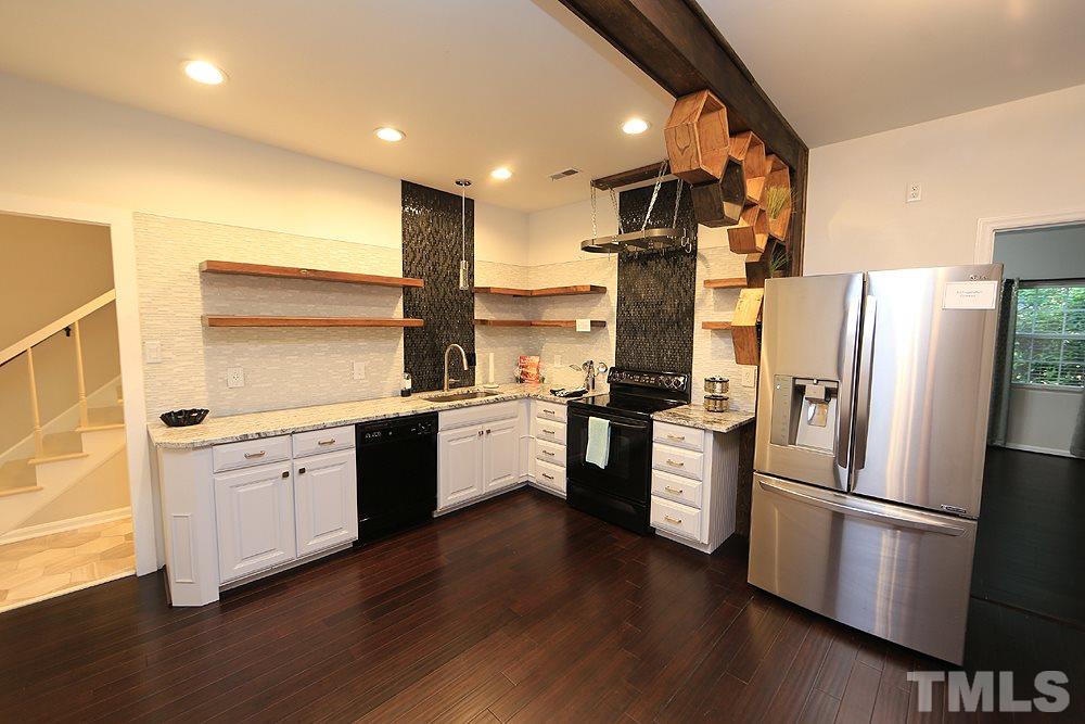6579 New Market Way, Unit 6579 Raleigh, NC 27615 - Photo 3 of 22 a kitchen with a refrigerator and a stove top oven