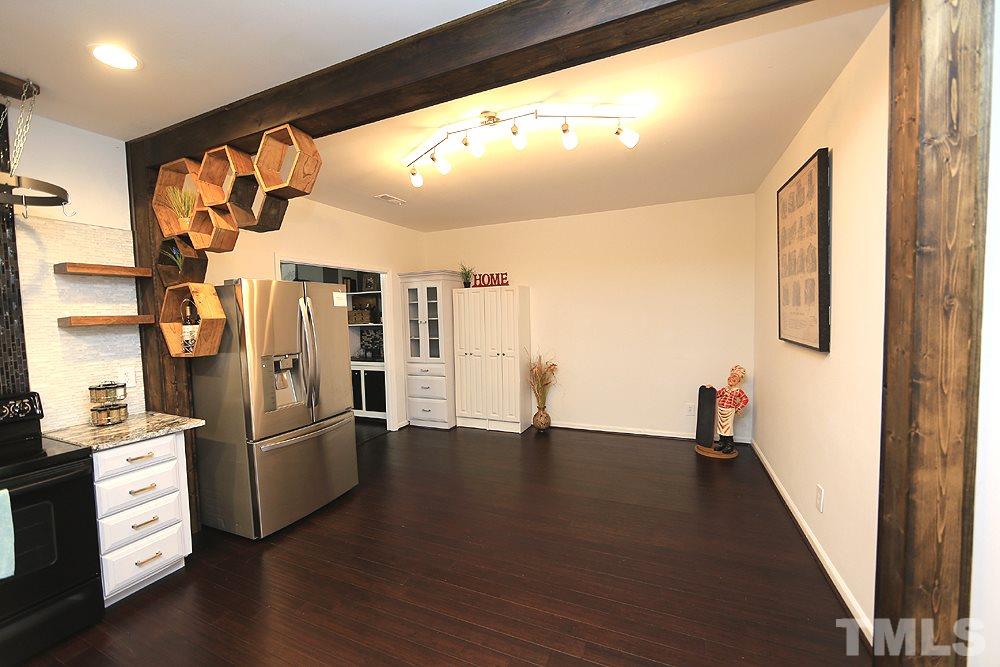 6579 New Market Way, Unit 6579 Raleigh, NC 27615 - Photo 4 of 22 a view of a hallway with wooden floor and staircase
