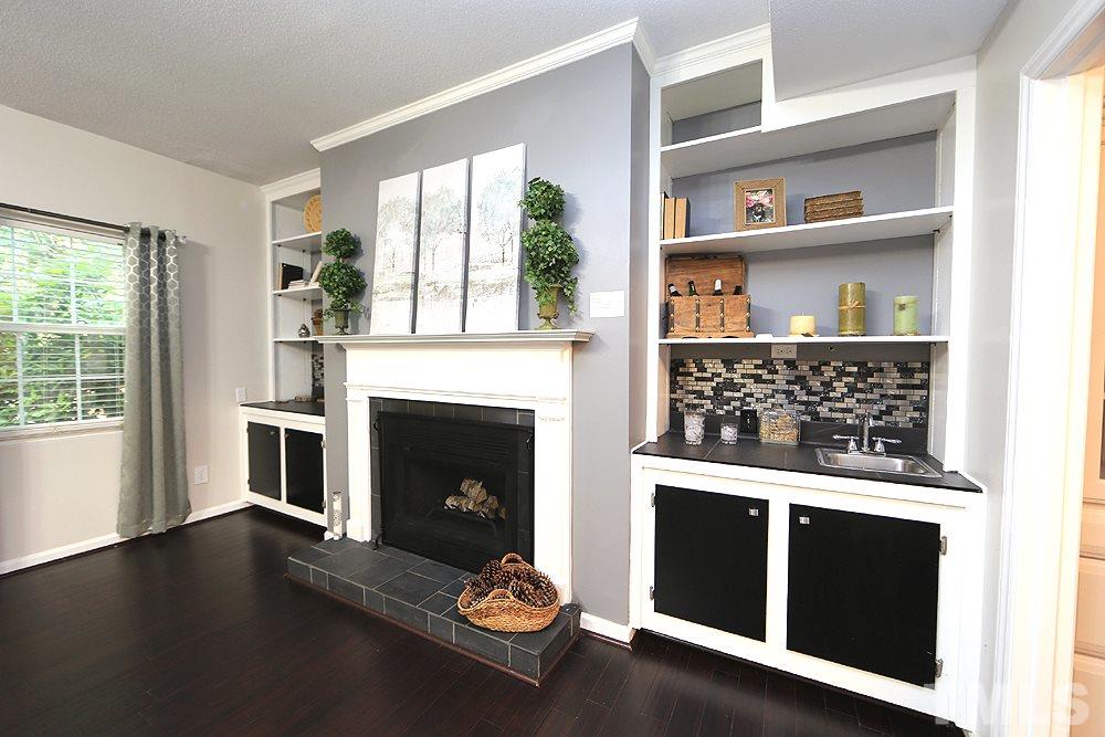 6579 New Market Way, Unit 6579 Raleigh, NC 27615 - Photo 6 of 22 a living room with a fireplace and a window