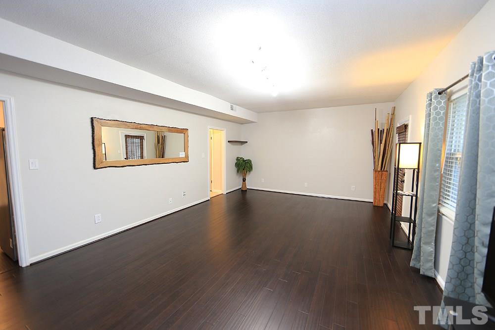 6579 New Market Way, Unit 6579 Raleigh, NC 27615 - Photo 7 of 22 a view of a livingroom with wooden floor and a window