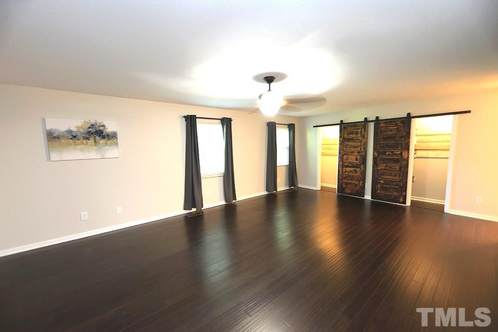 6579 New Market Way, Unit 6579 Raleigh, NC 27615 - Photo 8 of 22 a view of an empty room with wooden floor and a window