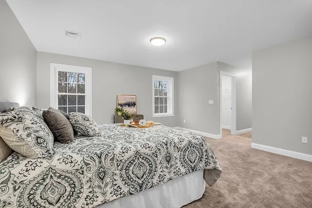 a bedroom with a large bed and a window