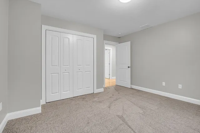 a view of an empty room and closet area