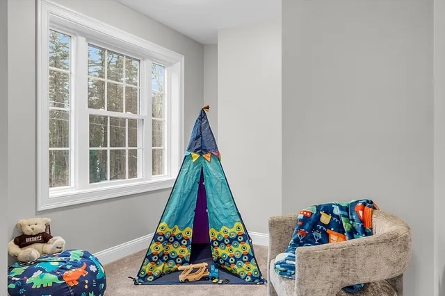 a room with toys and baby crib