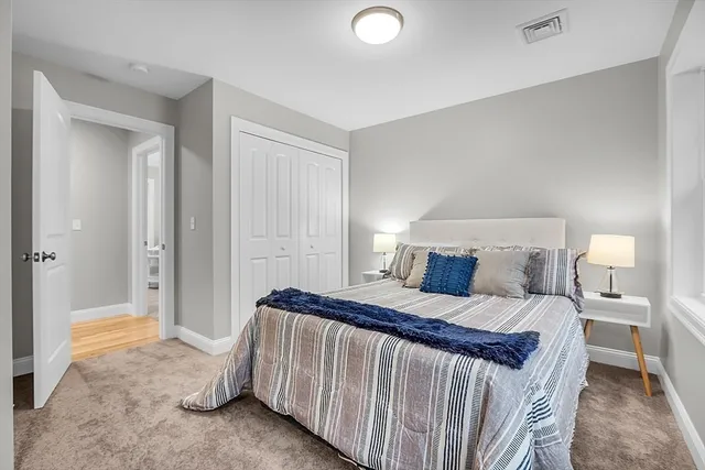 a bedroom with a bed and a mirror