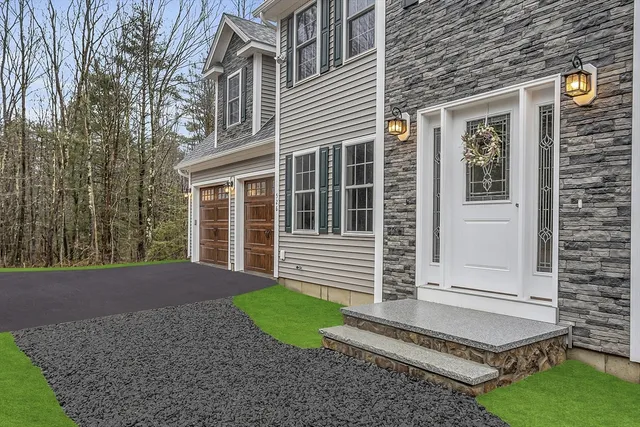a front view of a house with a yard