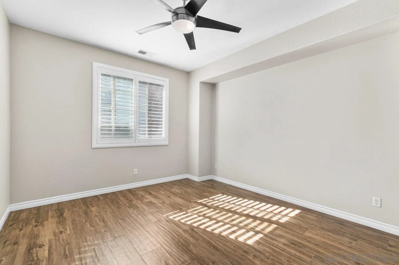 2957 Ranch Gate Road Chula Vista, CA 91914 - Photo 30 of 75 a view of an empty room with wooden floor and a window