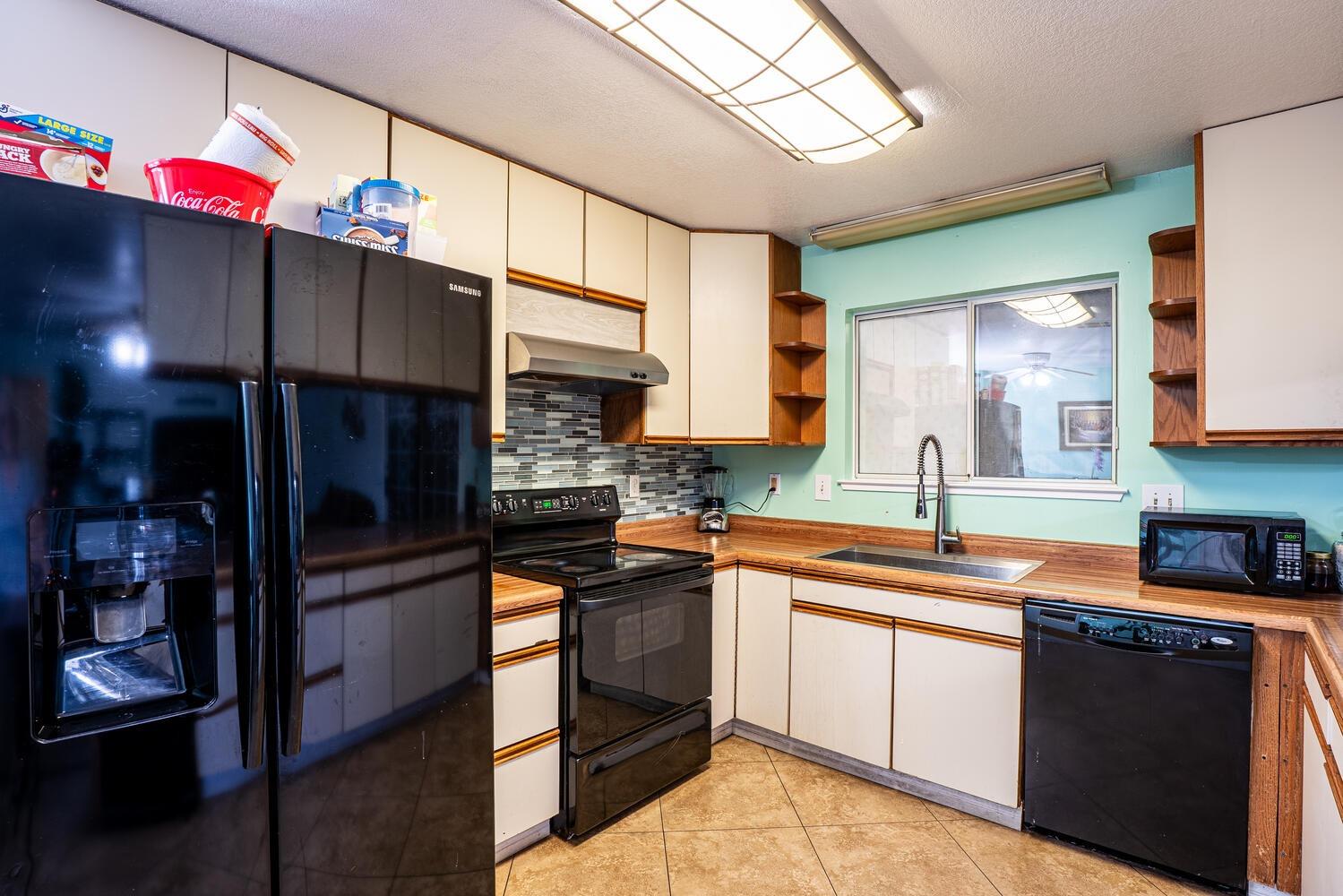 802 West Center Street Manteca, CA 95337 - Photo 13 of 29 a kitchen with stainless steel appliances granite countertop a sink stove and cabinets