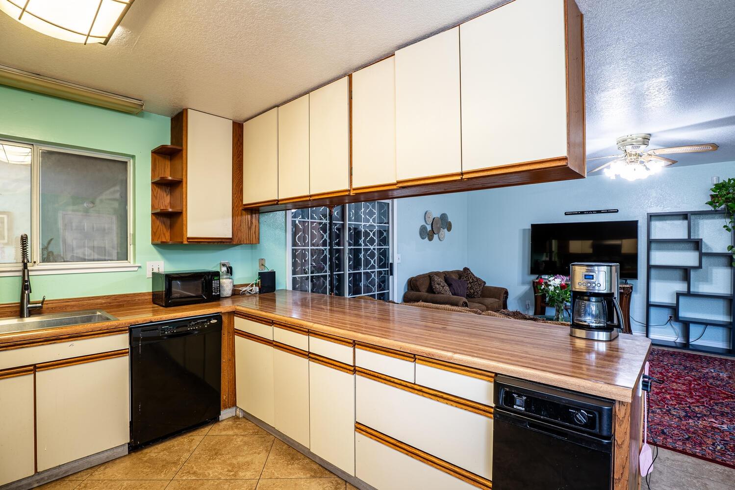 802 West Center Street Manteca, CA 95337 - Photo 14 of 29 a kitchen with stainless steel appliances granite countertop a sink and a stove