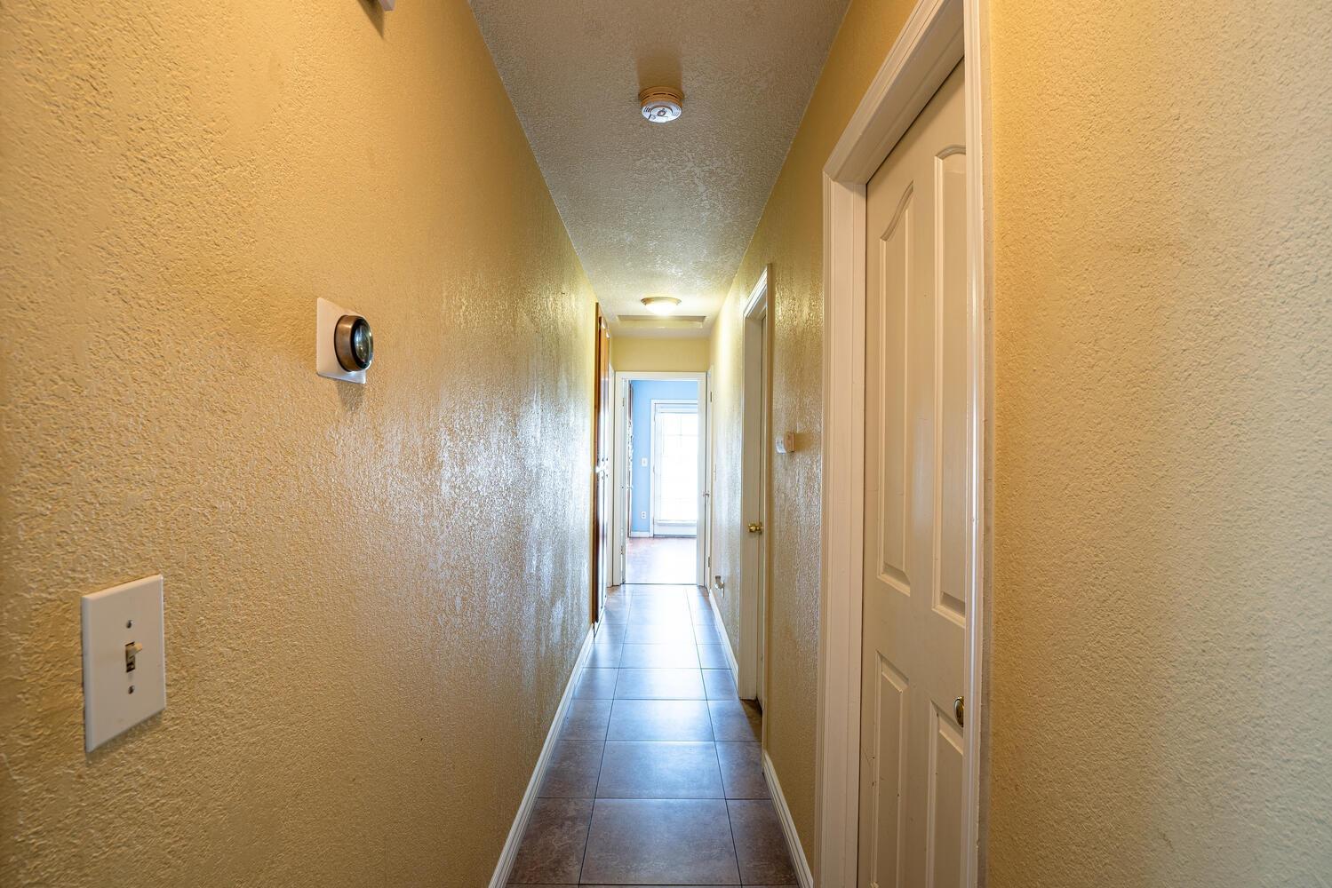 802 West Center Street Manteca, CA 95337 - Photo 21 of 29 a view of a hallway with wooden floor