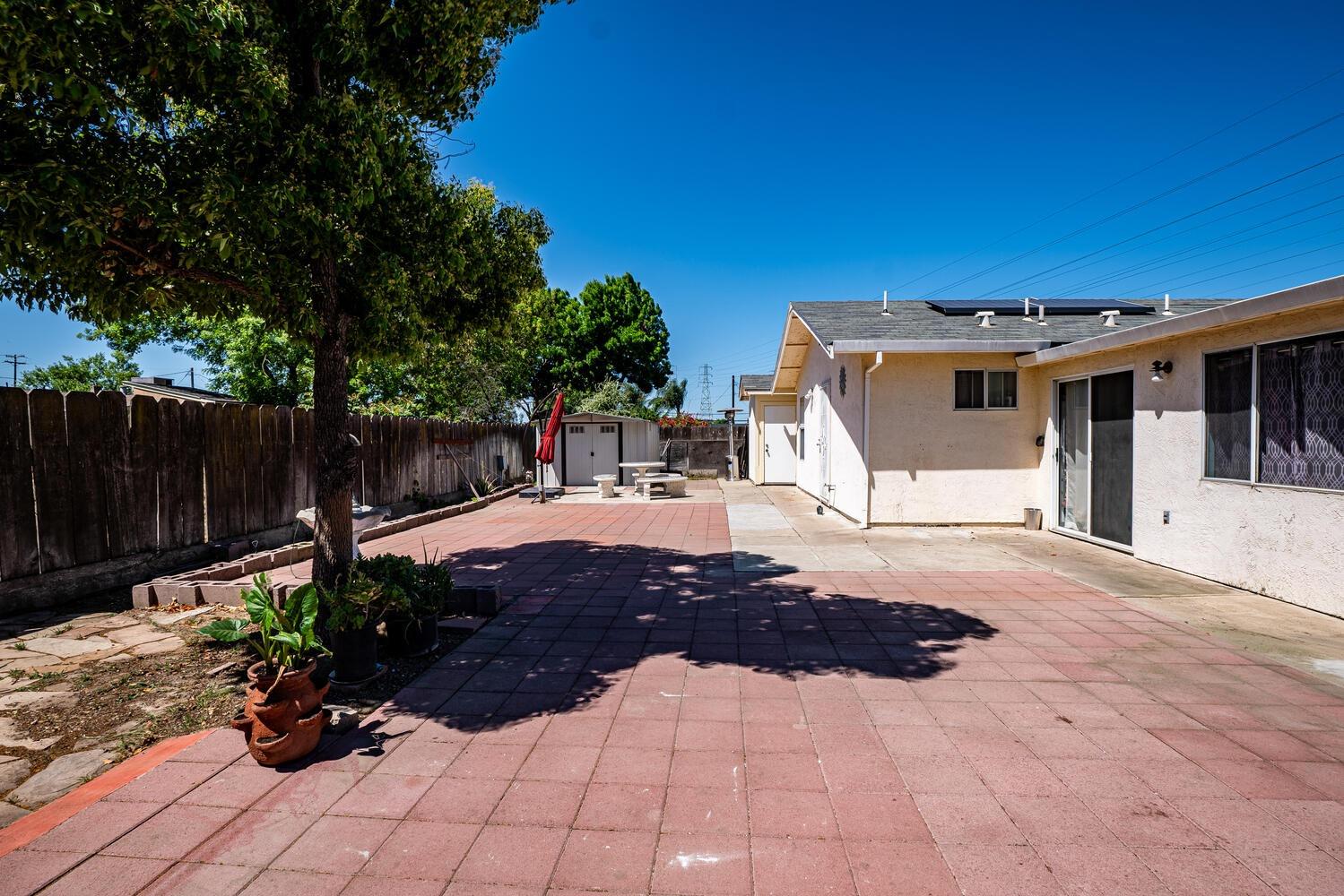 802 West Center Street Manteca, CA 95337 - Photo 23 of 29 a view of a patio with table and chairs with wooden fence and plants