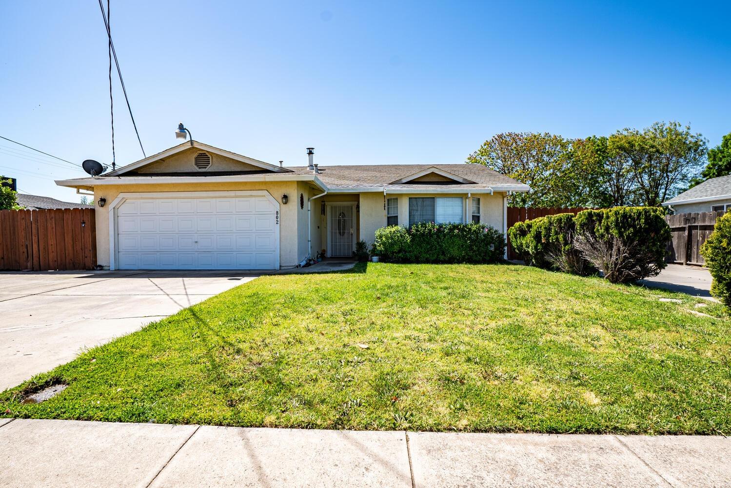 802 West Center Street Manteca, CA 95337 - Photo 3 of 29 a front view of a house with garden