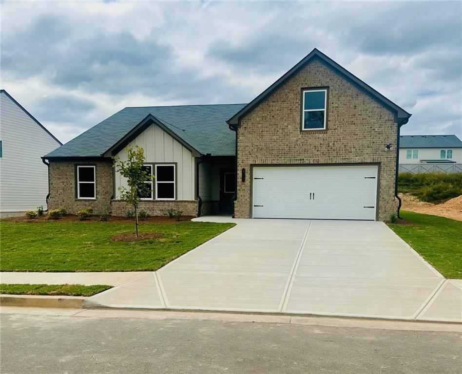 a view of a house with a yard and garage