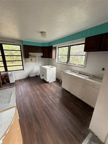 a view of a livingroom with furniture hardwood floor and a window