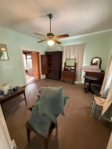 a living room with furniture a window and a wooden floor