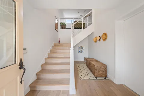 a view of entryway and hall with wooden floor