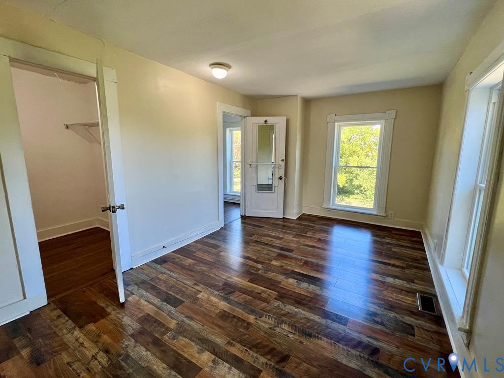 40 Coan Wharf Road Heathsville, VA 22473 - Photo 16 of 28 an empty room with wooden floor and windows
