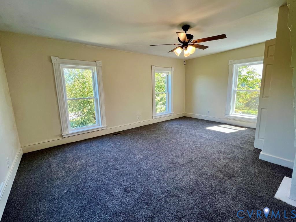 40 Coan Wharf Road Heathsville, VA 22473 - Photo 18 of 28 a view of an empty room with windows and chandelier fan