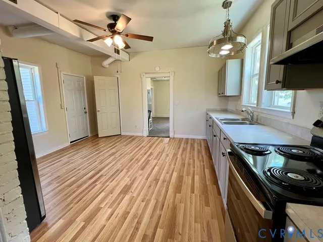 a bedroom with a bed and a flat tv screen on a dresser