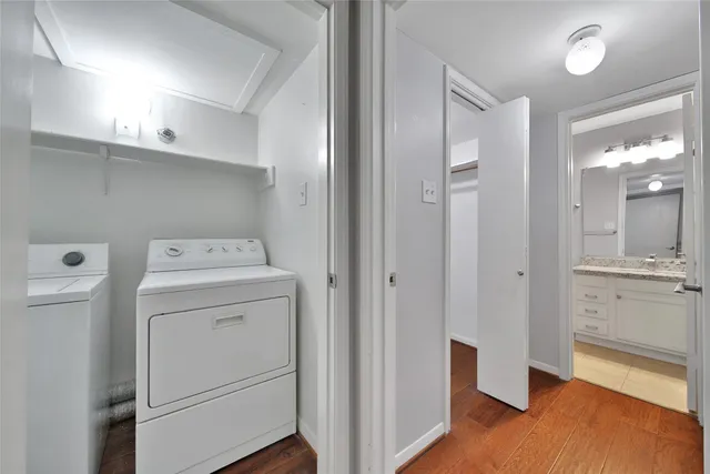 a view of washer and dryer with wooden floor