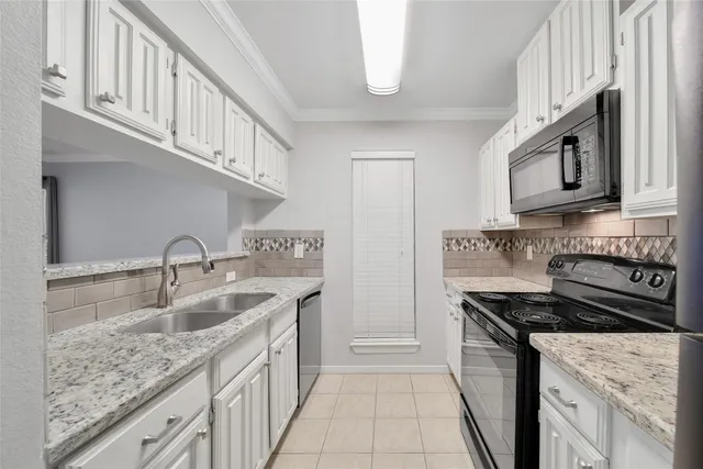 a kitchen with stainless steel appliances granite countertop a sink stove and cabinets