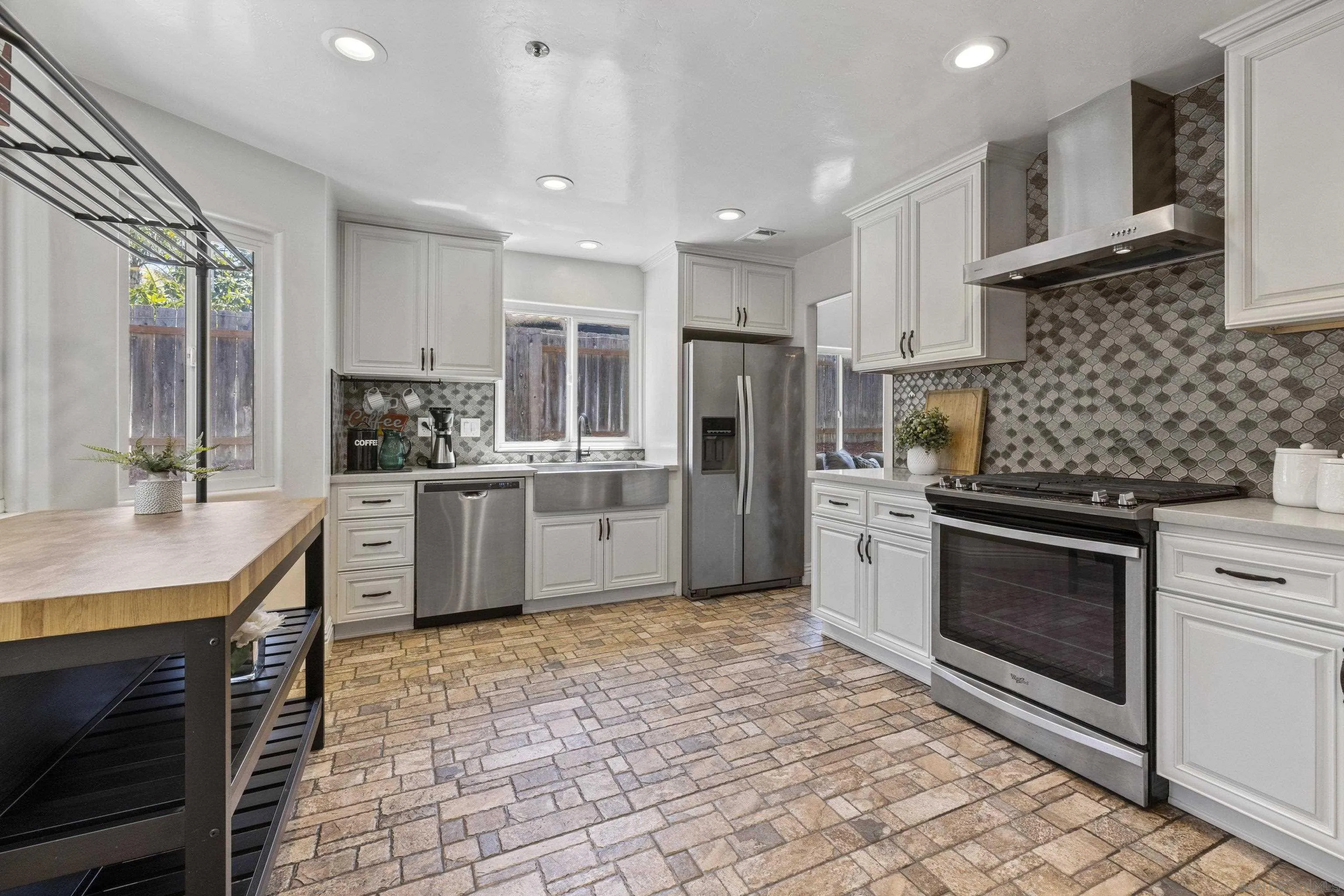 3127 Rio Way Spring Valley, CA 91977 - Photo 16 of 45 a kitchen with stainless steel appliances kitchen island granite countertop a sink stove and refrigerator