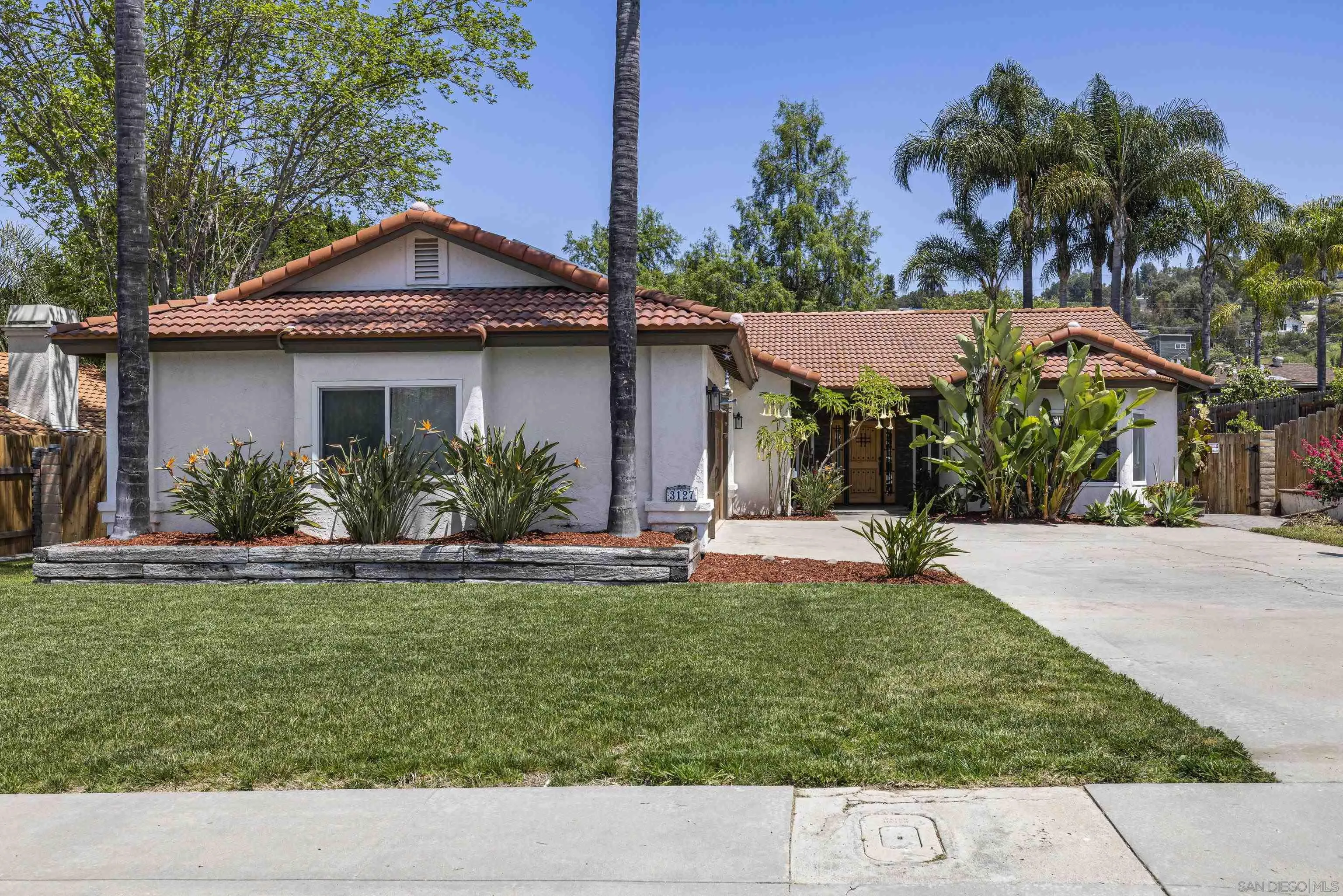 3127 Rio Way Spring Valley, CA 91977 - Photo 2 of 45 a view of a house with a yard and potted plants