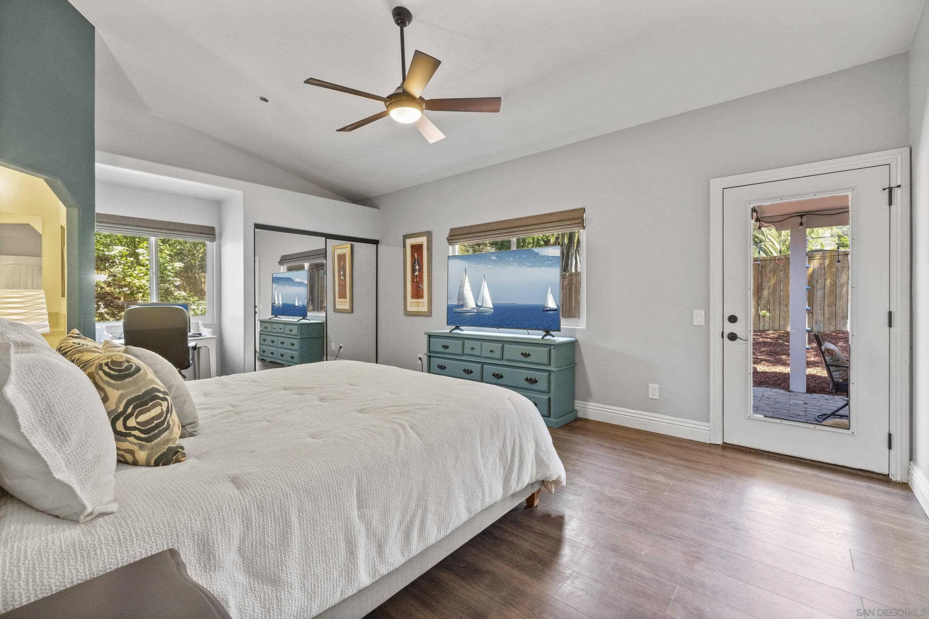 3127 Rio Way Spring Valley, CA 91977 - Photo 22 of 45 a spacious bedroom with a large bed a chandelier and windows
