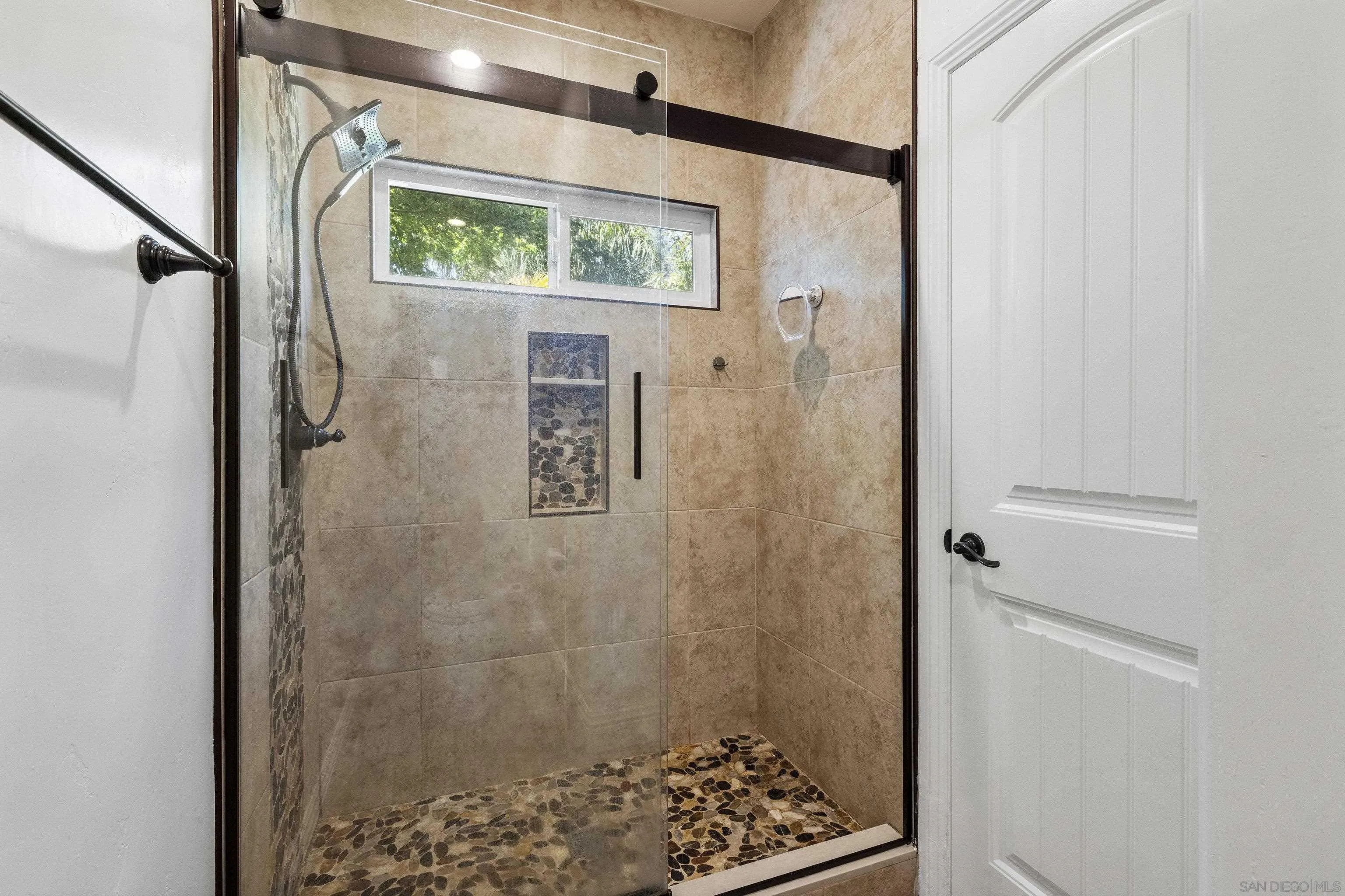 3127 Rio Way Spring Valley, CA 91977 - Photo 26 of 45 a bathroom with a shower and a sink