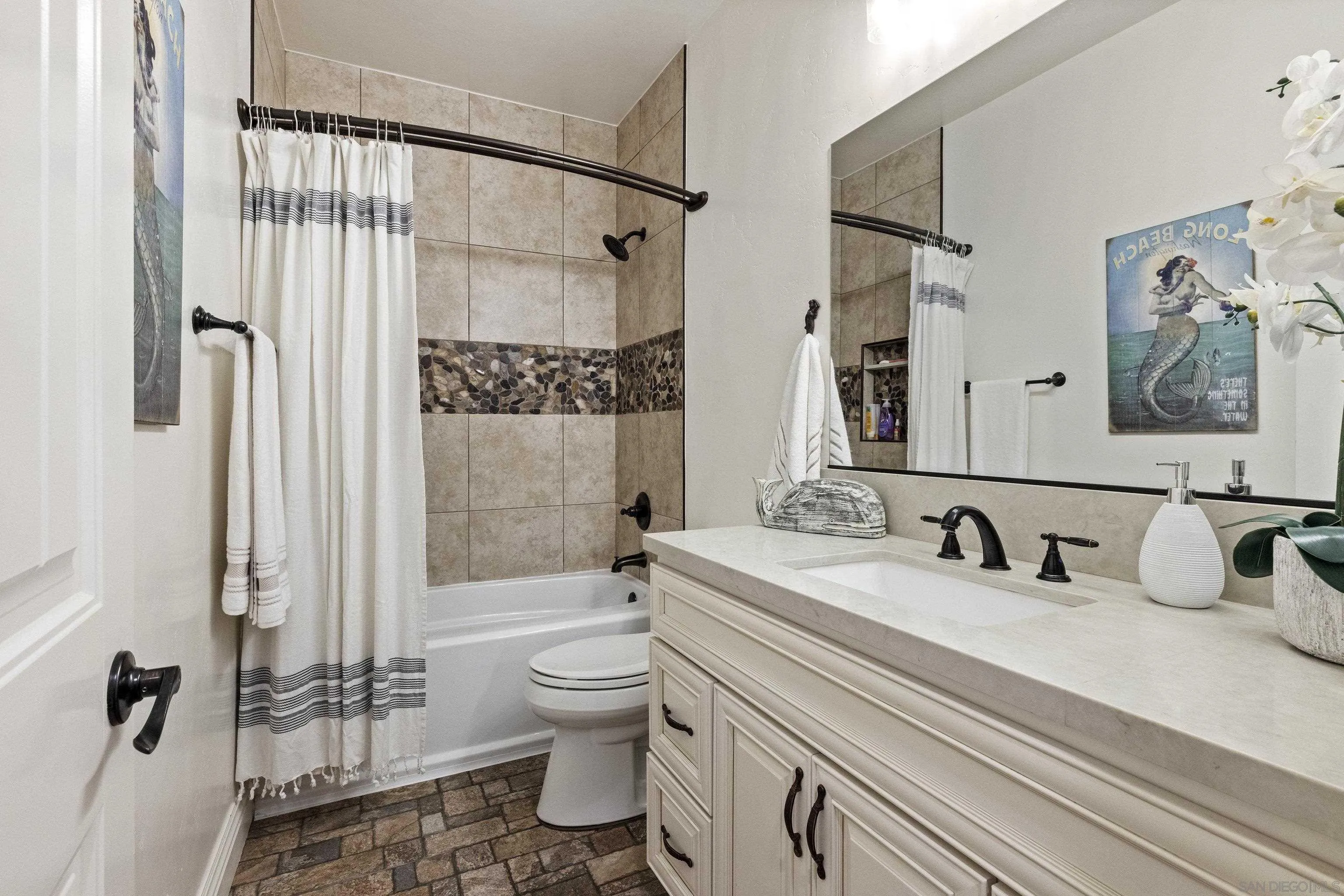 3127 Rio Way Spring Valley, CA 91977 - Photo 29 of 45 a bathroom with a double vanity sink toilet and shower