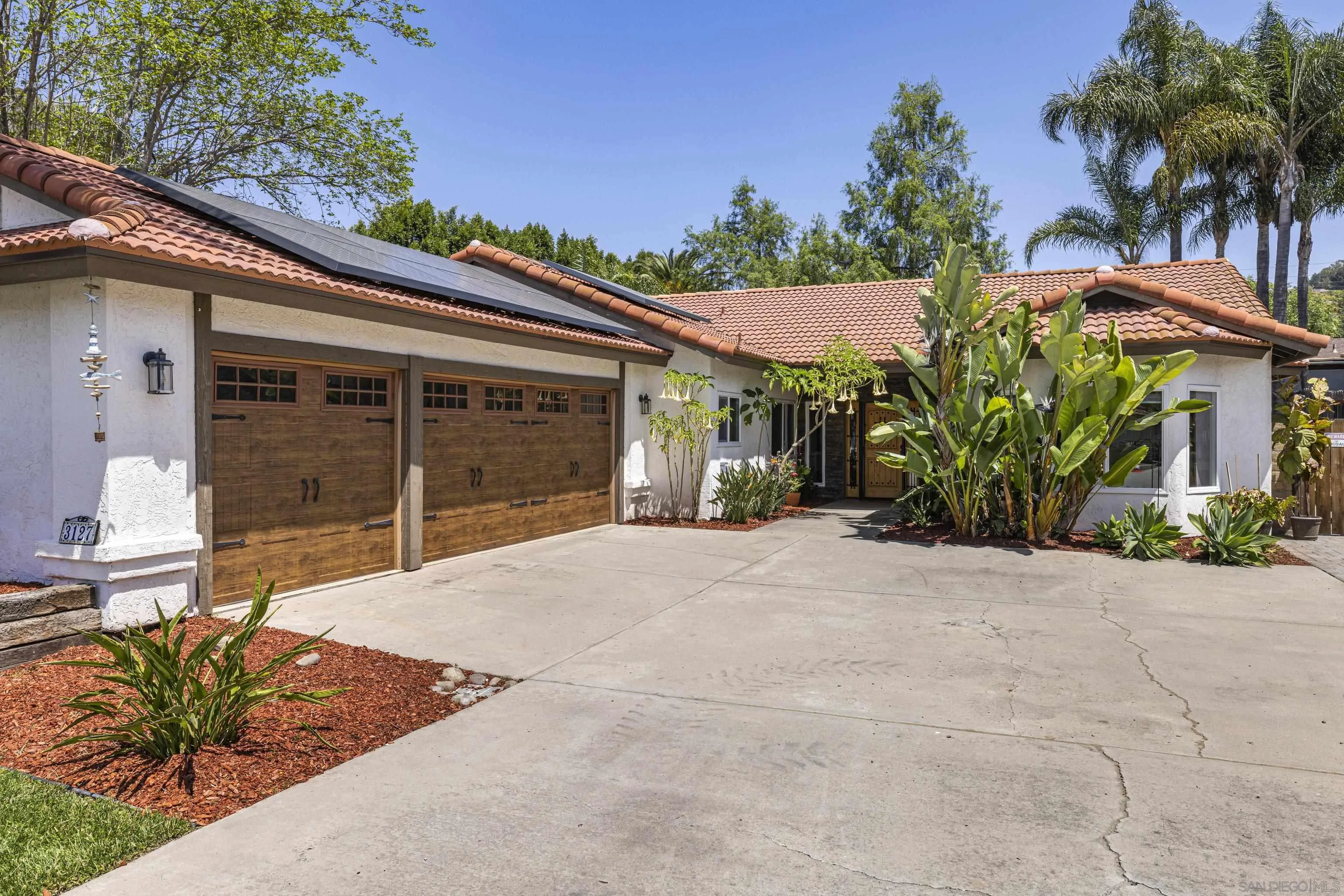 3127 Rio Way Spring Valley, CA 91977 - Photo 3 of 45 a view of a house with a yard and potted plants