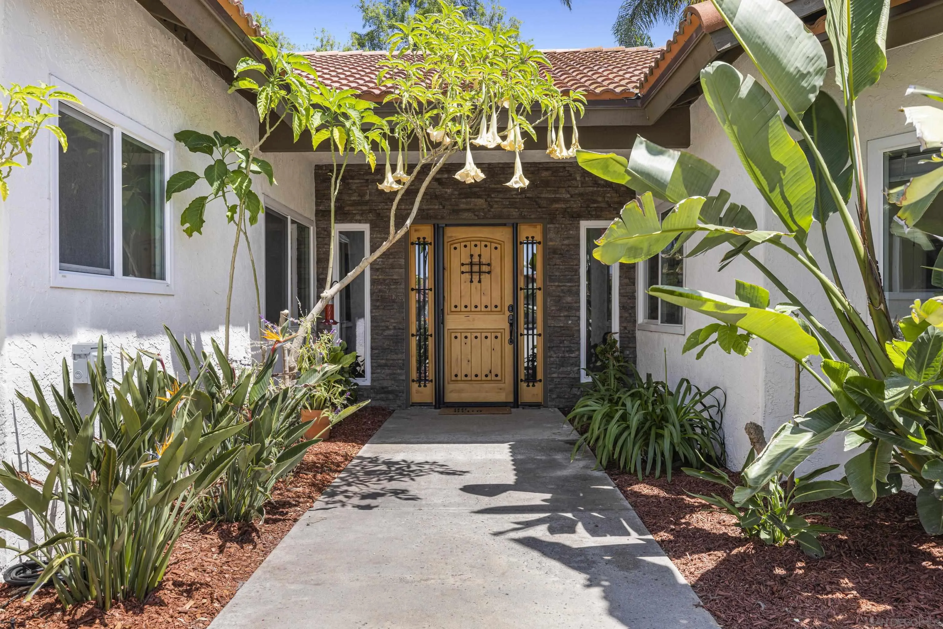 3127 Rio Way Spring Valley, CA 91977 - Photo 5 of 45 a front view of a house with a yard and potted plants