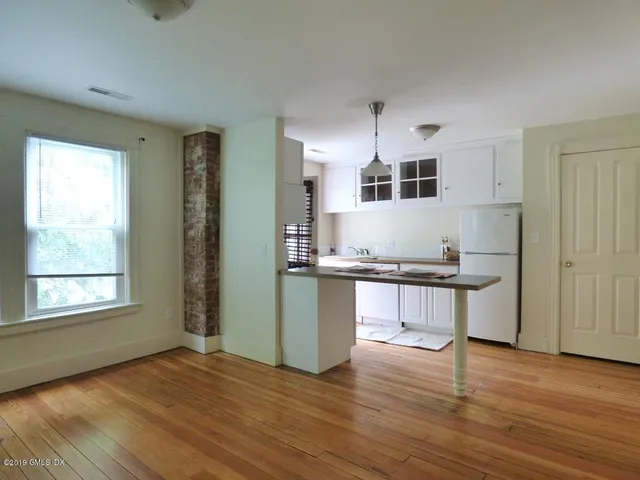 a kitchen with granite countertop a stove a sink and a window